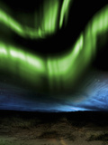 Illustration of the Aurora Borealis over Distant Hills at Night