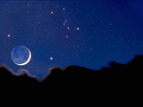 Crescent Moon with Earthshine Above a Cloud Layer with the Constellation Orion