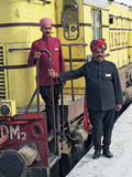 Staff Members for the Palace on Wheels Train Posing with the Train  Udaipur  India