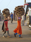 Two Young Indian Girls Carry Baskets of Animal Dung on their Heads