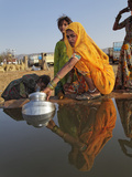 Women Gathering Water in Buckets from an Open Water Well  Pushkar Fair  India