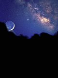 Crescent Moon with Earthshine Above a Cloud Layer with the Milky Way in the Background