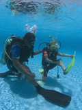 Young Girl Being Shown by Instructor How to Alleviate Cramp During Padi Junior Open Water Course