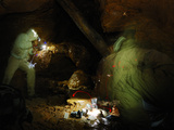 Two Speleologist Photographing in the Deep Darkness of a Cave  Italy