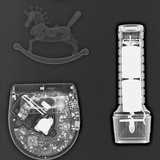 X-Ray of a Cd Player  a Flashlight  and a Toy Horse