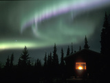 Aurora Borealis on a Cold Winter Night over a Cabin in the Taiga  Alaska  USA