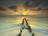 Sunset Behind an Old Eroded Pier Extending into the Ocean Near Cancun  Mexico