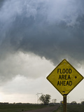 A Road Sign Warns of Flooding on a Rural Road in Kansas as a Tornadic Thunderstorm Spins Above
