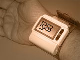 Hand of a Adult Male Wearing a Wrist Cuff for Measuring Blood Pressure