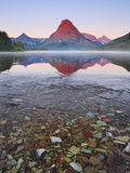 Dawn Light Sets the Peaks Aglow over Misty Two Medicine Lake  Glacier National Park  Montana  USA