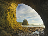 Wispy Cirrus Clouds and a Seastack Seen Through Hole in the Wall Accessible Only at Low Tide