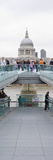 People on a Bridge with a Cathedral in the Background  London Millennium Footbridge  St Paul's 