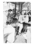 Enrico Caruso Leans Back on Chair Holding a Board with Music