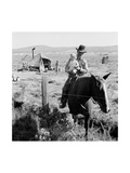 Cowboy Holds His Baby While Riding a Horse