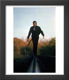 Country Music Star Johnny Cash Walking Along Line of Railway Track with His Guitar