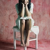 A Young Woman Sat on a Stool