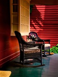 An American Front Porch with Wooden Boarding and Two Whicker Rocking Chairs