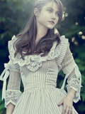 A Girl Looking to One Side Wearing a Victorian Striped Dress