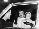 President John and Jacqueline Kennedy in a Limousine with their Four Year Old Daughter Caroline