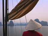 Girl with Conical Hat on a Junk Boat and Karst Islands in Halong Bay  Vietnam
