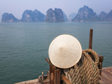 Conical Hat on Junk Boat and Karst Islands in Halong Bay  Vietnam