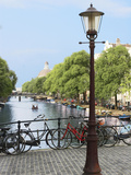 Old Gas Lamp Post and Bicycles on a Bridge over a Canal in Amsterdam  the Netherlands