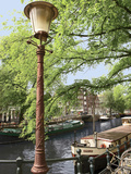 Old Gas Lamp Post and Bicycles on a Bridge over a Canal in Amsterdam  the Netherlands