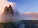 Fly Geyser with Snow Capped Granite Range in the Black Rock Desert Near Gerlach  Nevada  USA