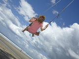 Young Girl on Rope Swing under Pohutukawa Tree  Waihi Beach  Coromandel  North Island  New Zealand