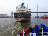 Tugboat and Freighter in Harbour  Hamburg Seaport  Germany  Europe