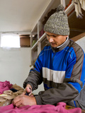 Middle Aged Male Nepali Factory Worker Cutting Fabric in a Factory  Kathmandu  Nepal  Asia