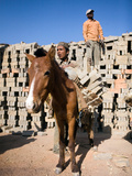 Donkey Getting Unloaded by Young Male Nepali Worker in Outdoor Brick Kiln  Kathmandu  Nepal