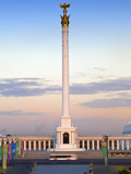 Bus Passing Kazakyeli Monument (Kazakh Country) at Dusk  Astana  Kazakhstan  Central Asia  Asia
