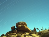 Time Exposure of Stars across Sky with Rock Formations  Joshua Tree Nat'l Park  California  USA