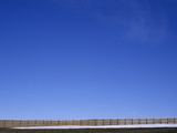 A Long Fence under a Blue Sky