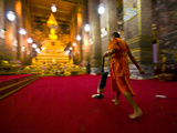 A Buddhist Monk Vacuums the Chapel's Red Carpet after Evening Prayer
