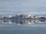 Snow and Mountains Reflected in Still Arctic Water
