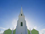Sunlight Gleams Behind a Church as it Begins to Set