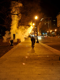 A Biker Riding Through Steam Coming Form the Metro
