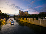 The Seine at Sunset with Notre Dame in the Background and a Tour Boat