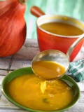 Pumpkin Soup Being Poured into Soup Plates