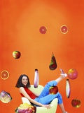 Woman Sitting in Chair Surrounded by Flying Fruit and Vegetables
