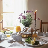 Laid Breakfast Table with Baked Goods  Juice and Fruit