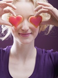 Young Woman Holding Hearts in Front of Her Eyes