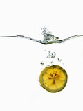 Slice of Lemon Falling into Water