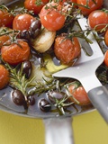 Fried Cherry Tomatoes with Garlic and Olives in Frying Pan