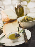 Cheese  Olives and Olive Oil on Table Out of Doors