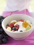 Honey Running onto Fruit Muesli with Yoghurt