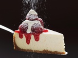 Slice of Cheesecake with Raspberries  Cream  Icing Sugar on Server