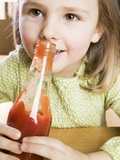 Girl Holding a Bottle of Ketchup
